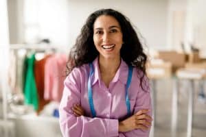 Smiling seamstress in shop
